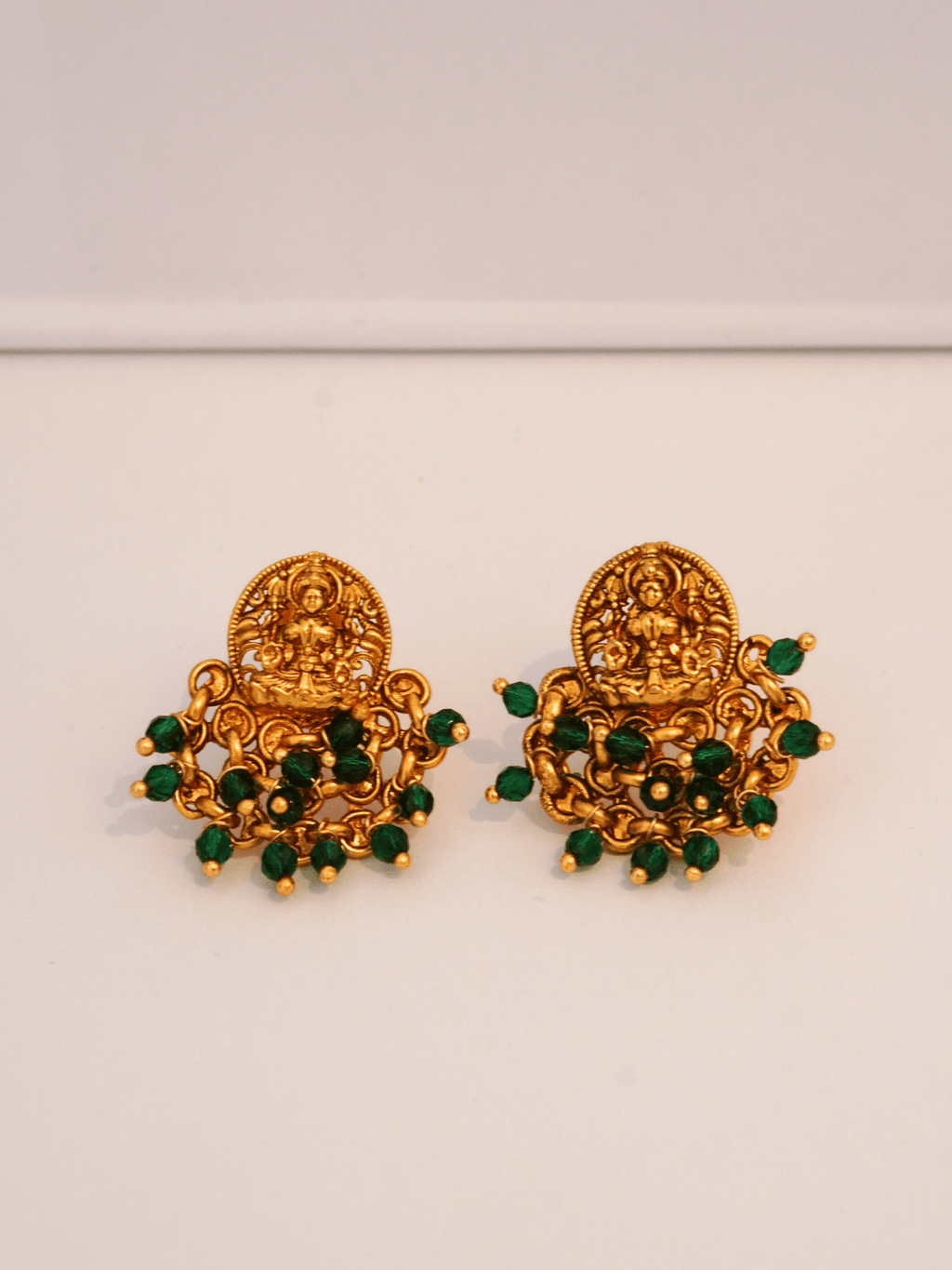 Elegant Laxmi Temple Studs with Green Crystals in 22KT Gold Matte
