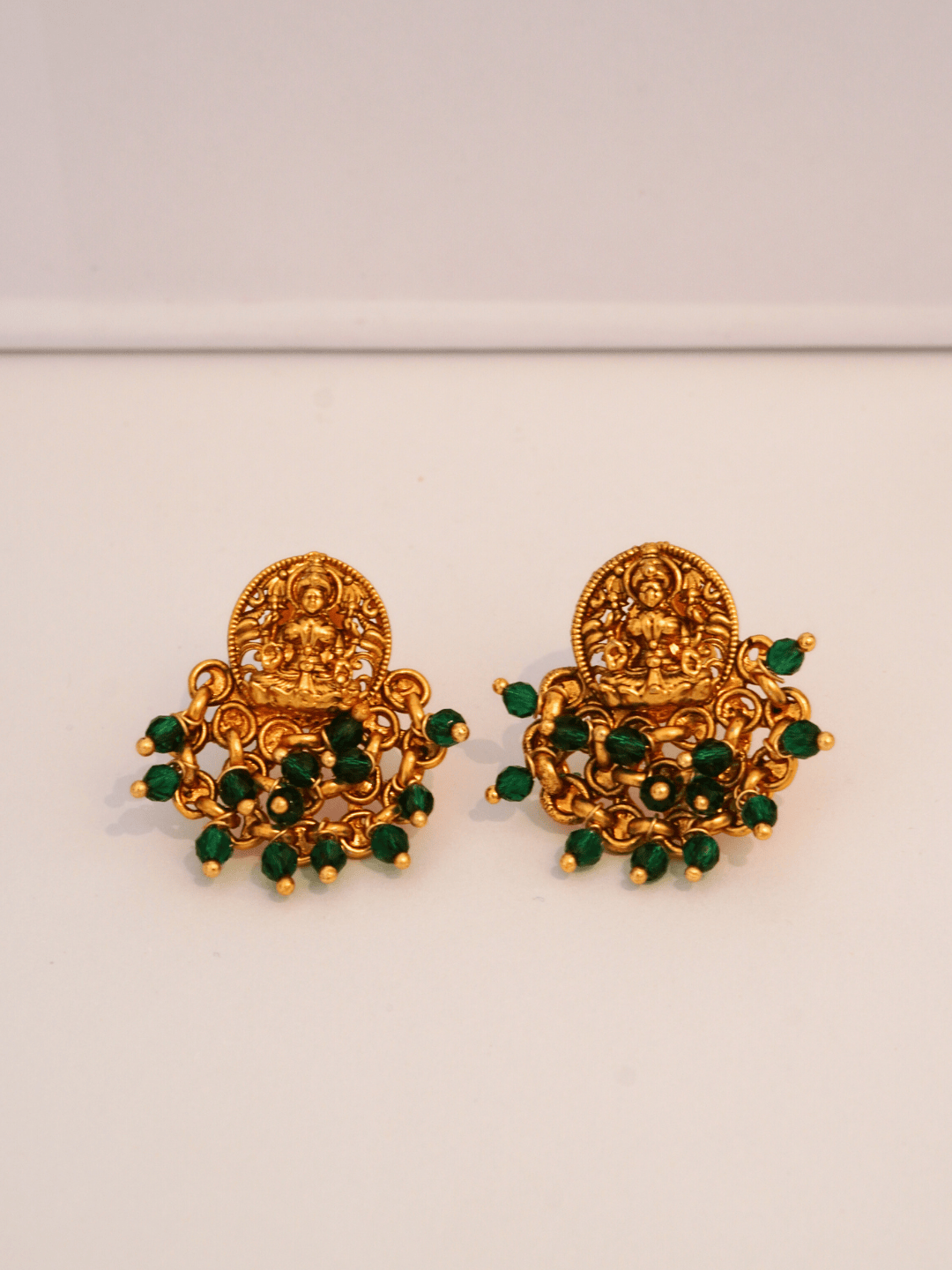Elegant Laxmi Temple Studs with Green Crystals in 22KT Gold Matte