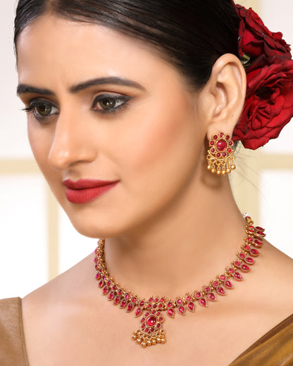 Ruby Studded Leafy Pattern Brass Alloy Matte Gold Plated Traditional Necklace Set with Stud Earrings