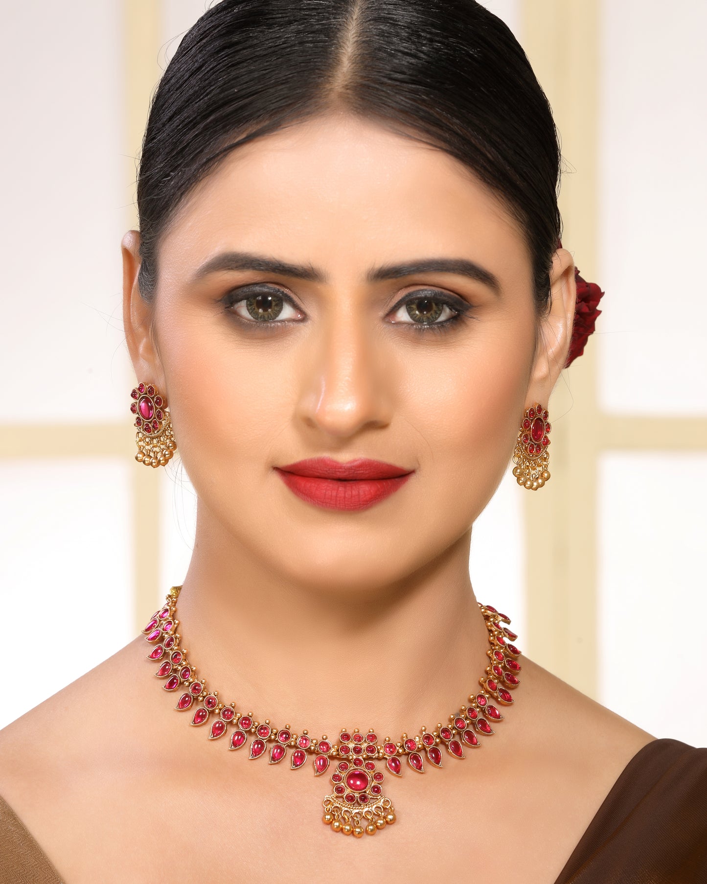 Ruby Studded Leafy Pattern Brass Alloy Matte Gold Plated Traditional Necklace Set with Stud Earrings