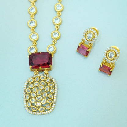 Indo-Western Cum Traditional Brass Pendant Chain Necklace Set Studded with Zirconia, Crystals and Statement Bold Red Crystal with Stud Earrings