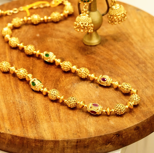 Kemp Stone Studded Slope Down Beaded Necklace Set with Jhumka Earrings in High Gold Plated Brass