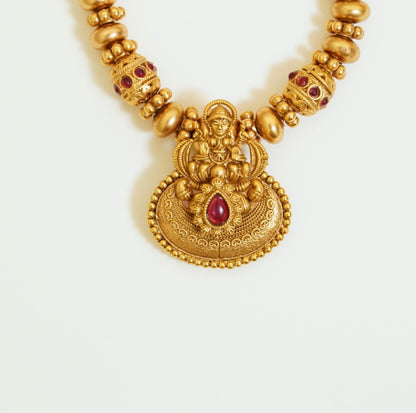 Divine Beaded Matte Finish Gold Plated Laxmi Pendant Traditional Temple Brass Necklace Set with Stud Earrings