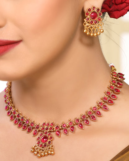 Ruby Studded Leafy Pattern Brass Alloy Matte Gold Plated Traditional Necklace Set with Stud Earrings