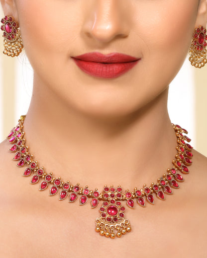 Ruby Studded Leafy Pattern Brass Alloy Matte Gold Plated Traditional Necklace Set with Stud Earrings