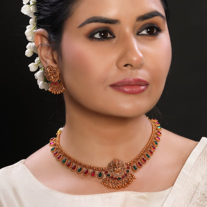 Traditional Temple Brass Necklace set with Stud Earrings in Matte Gold Finish Adorned with Ruby and Green Crystal Beads