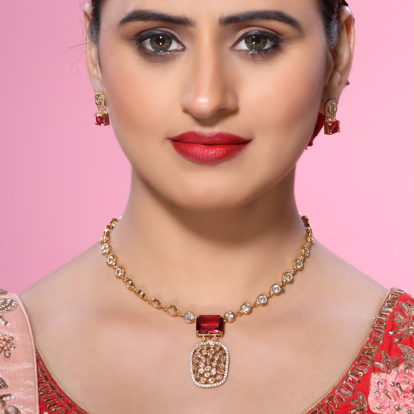 Indo-Western Cum Traditional Brass Pendant Chain Necklace Set Studded with Zirconia, Crystals and Statement Bold Red Crystal with Stud Earrings