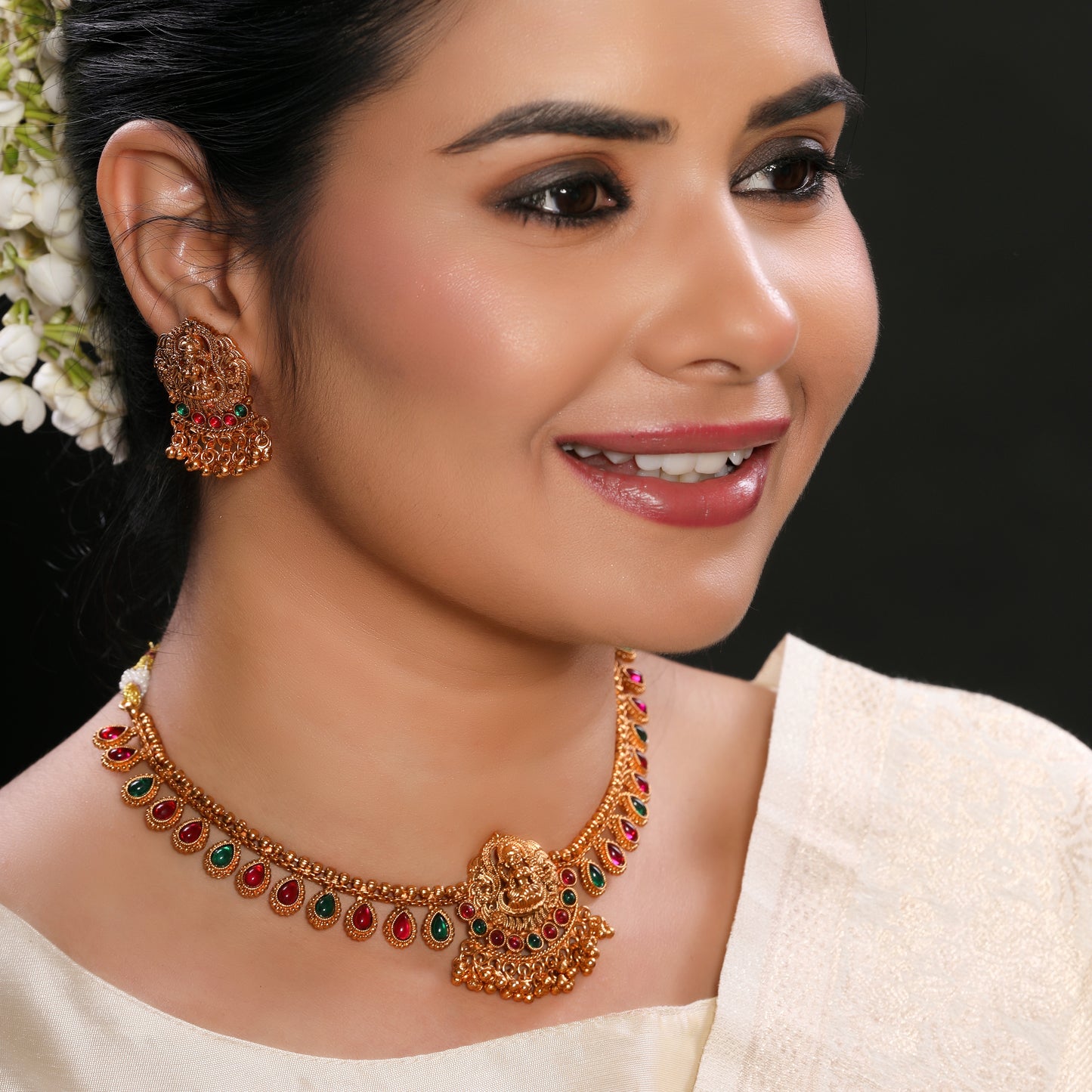 Traditional Temple Brass Necklace set with Stud Earrings in Matte Gold Finish Adorned with Ruby and Green Crystal Beads