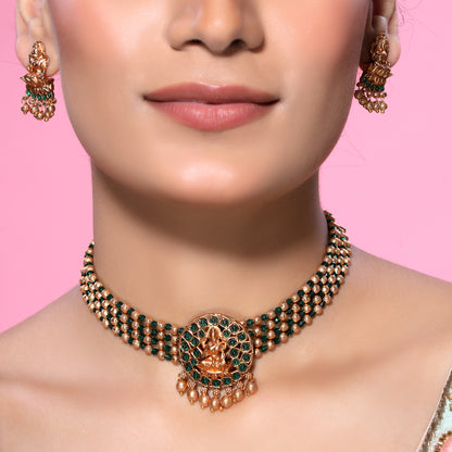 Green Crystals and Golden Beads Studded Traditional Temple Laxmi Pendant Brass Matte Finish Gold Choker Set with Stud earrings