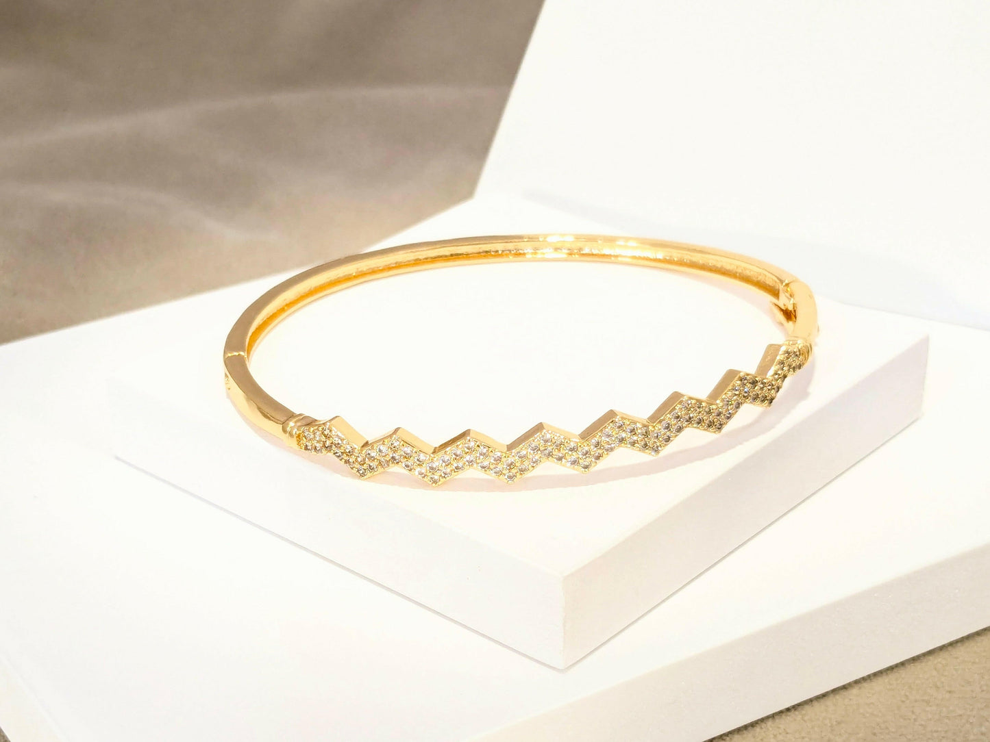 Sleek Golden Bracelet studded with fine American Diamonds