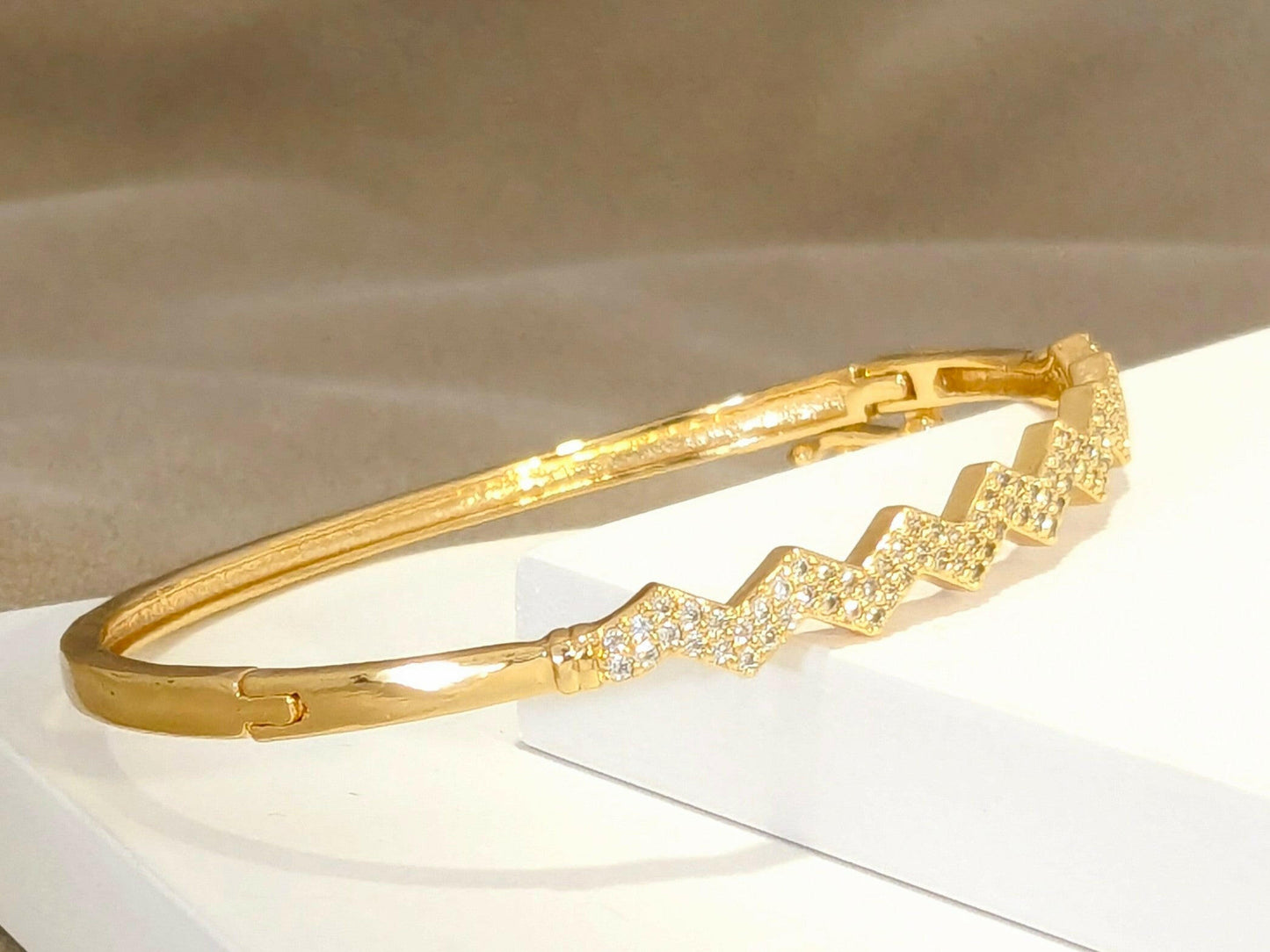 Sleek Golden Bracelet studded with fine American Diamonds