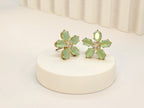 Sea Green Stone Flower Pattern AD Stud Earrings in Gold Finish