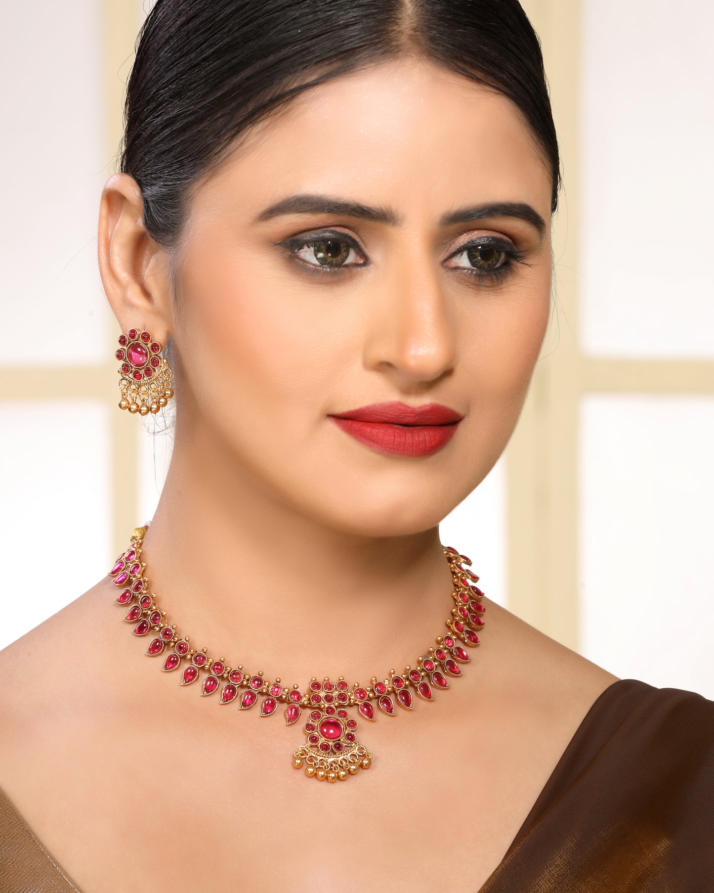 Ruby Studded Leafy Pattern Brass Alloy Matte Gold Plated Traditional Necklace Set with Stud Earrings