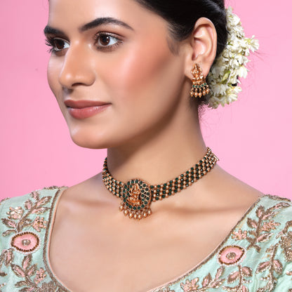 Green Crystals and Golden Beads Studded Traditional Temple Laxmi Pendant Brass Matte Finish Gold Choker Set with Stud earrings