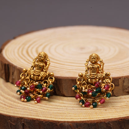 Traditional Temple Laxmi Studs in Brass 22KT Gold Plating Matte Finish studded with Red n Green Crystal Beads